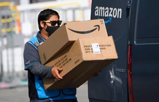 A man delivers packages from Amazon